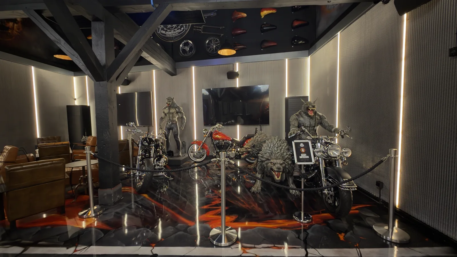 Werewolf figures and custom bikes behind the barrier in the barn