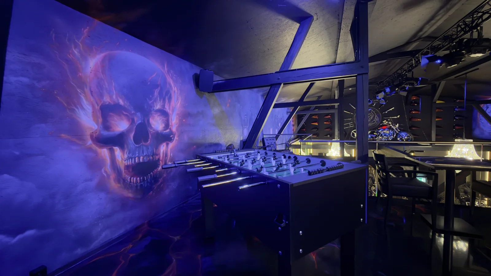 Table football in front of the barn's flaming skull graffiti